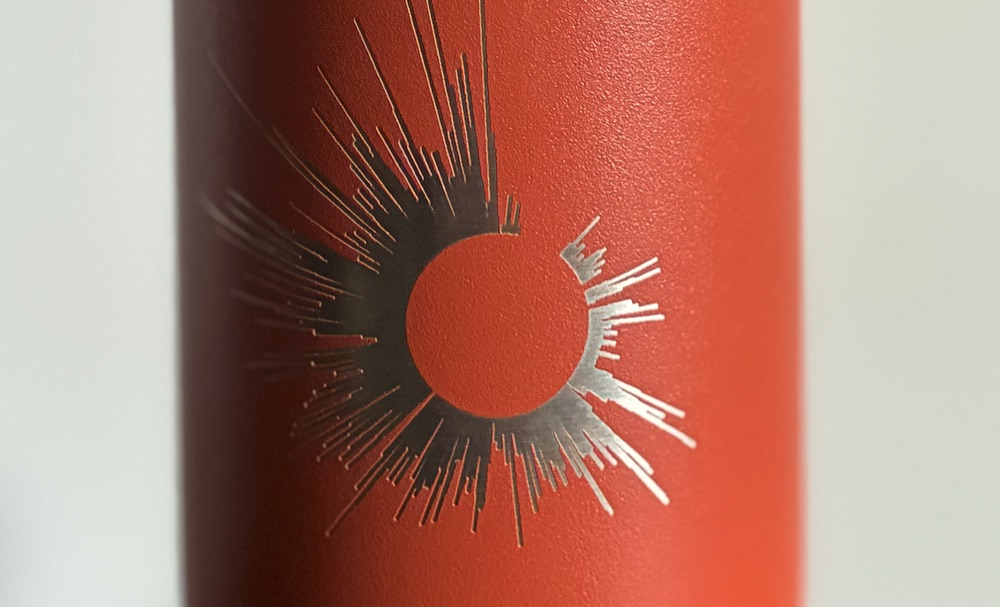 A repo's Git history, engraved on a coffee tumbler